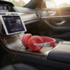 Red 958BT Wireless Headphones plugged into a tablet, resting on a luxurious car's wooden console.