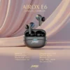 Luxury Airox E6 black wireless earbuds with blue accents, open charging case, and elegant pink fabric background.