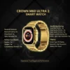 Elegant gold Crown M60 Ultra 2 Smart Watch with a metallic link band and illuminated display on a dark background.