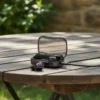 M10 TWS Wireless Bluetooth Earbuds: open charging case with cable, one earbud beside it on a wooden table.