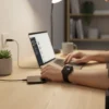 M7 Pro Smart Watch on user's wrist, displaying health stats, while working on a laptop at a desk.