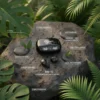 Black Mars MB-10 wireless earbuds and case on a wet rock, surrounded by lush green tropical leaves.